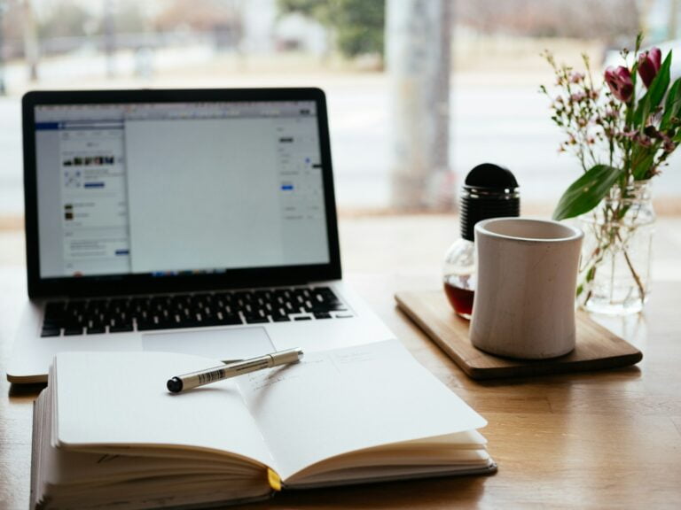 MacBook Pro near white open book-Email Marketing Content-Top Email Marketing Tools