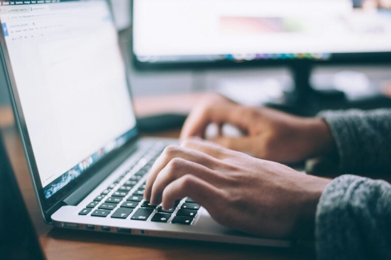 person using MacBook Pro- Mailchimp pricing plans