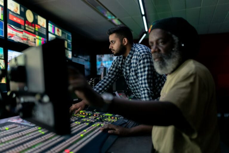 man in blue and white checkered button up shirt sitting beside man in yellow shirt-email automation software
