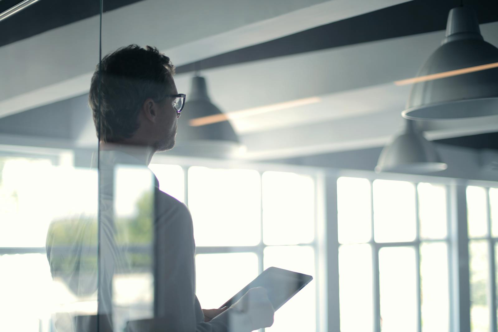 Formal man with tablet giving presentation in office-Email Marketing Courses