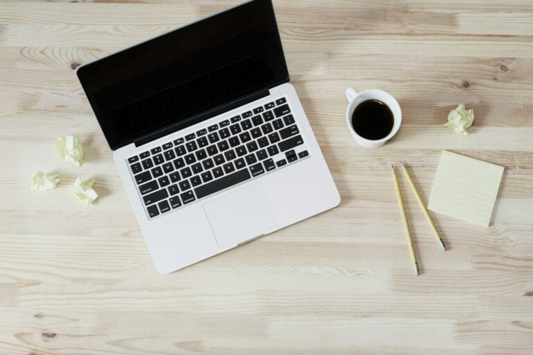 turned off MacBook Pro beside white ceramic mug filled with coffee-Understanding the types of email marketing is crucial for developing a successful email marketing strategy.
